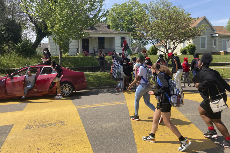 In this April 27, 2021 photo, students walk out of school at Austin-East Magnet High School in Knoxville, Tenn. Members of the Black community in Knoxville, Tennessee, are calling for reforms to dispel longstanding disparities between Blacks and whites. They say that is one of the steps that needs to be taken to reduce increasing violence that has claimed the lives of five high school-age students this year. (AP Photo/Kimberlee Kruesi)