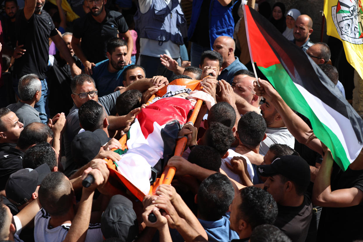 Relatives and others mourn as they carry the body of a 7-year-old Palestinian child who purportedly died while being chased by Israeli forces, at his funeral in the town of                  Taquo near Bethlehem, West Bank, September 30, 2022. / Credit: Wisam Hashlamoun/Anadolu Agency/Getty