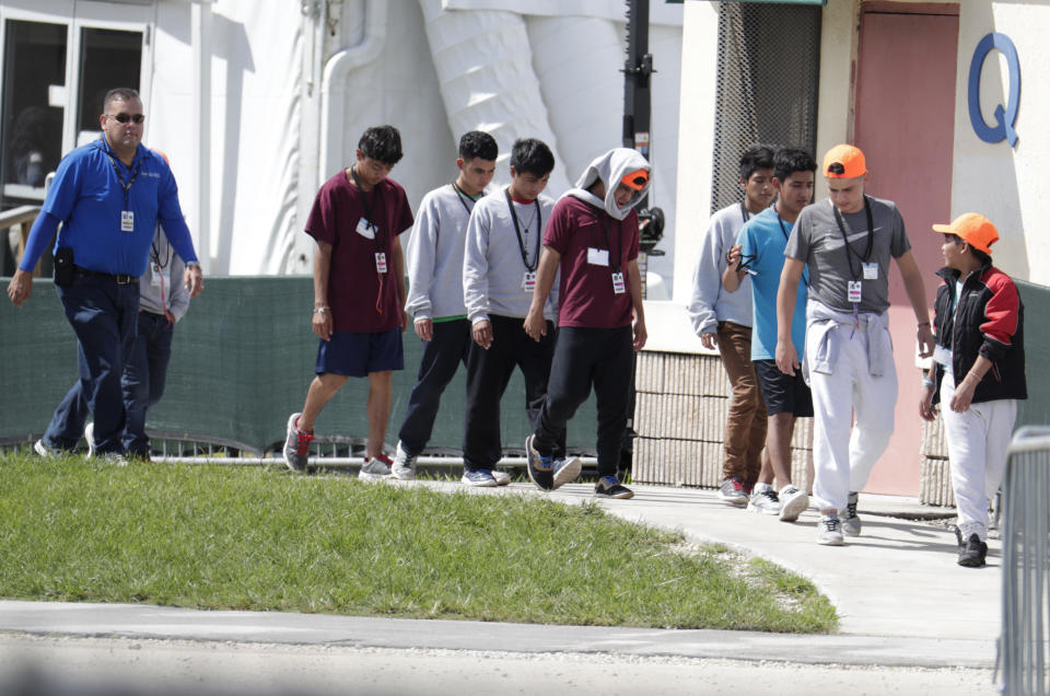 Migrant children walk on the grounds of the Homestead Temporary Shelter for Unaccompanied Children, Monday, July 15, 2019, in Homestead, Fla. (AP Photo/Lynne Sladky)