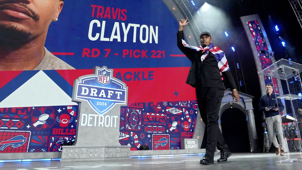 Clayton wears a United Kingdon flag on his shoulders on stage after being drafted by the Bills. - Jeff Roberson/AP