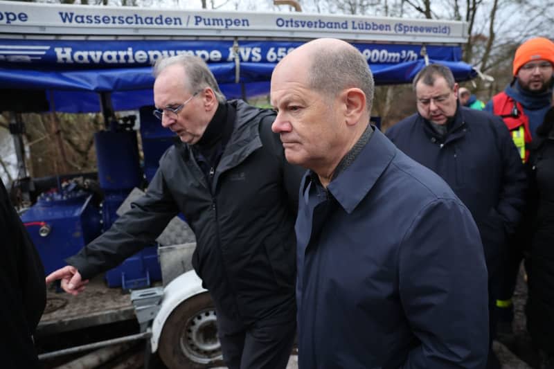 German Chancellor Olaf Scholz (C) and Reiner Haseloff (L), Minister President of Saxony-Anhalt, on their way to flood-affected areas in Sangerhausen. On the same day, Chancellor Scholz and Saxony-Anhalt's Minister President Haseloff will visit the flood area around the Helme and talk to volunteers. Jan Woitas/dpa