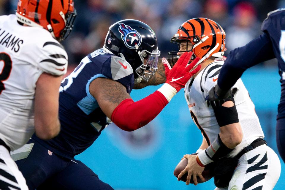 Tennessee Titans defensive end Jeffery Simmons (98) sacks Cincinnati Bengals quarterback Joe Burrow (9) on third down forcing a field goal in the second quarter during an NFL divisional playoff football game, Saturday, Jan. 22, 2022, at Nissan Stadium in Nashville, Tenn.