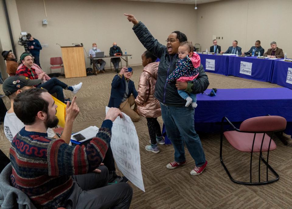 Doris Jones, with her two children, fires up the crowd at Indianapolis’ Library Services Center, Monday, Dec. 19, 2022, during an often contentious Indianapolis Public Library board meeting. At hand was the handling of a recent search for a new CEO, and widespread public opinion that Interim CEO Nichelle Hayes be retained as permanent CEO