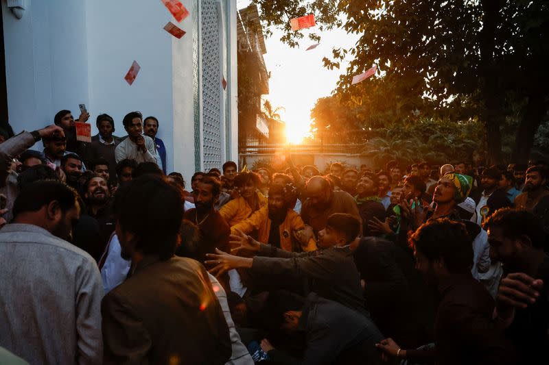 Supporters of Former Prime Minister of Pakistan Nawaz Sharif cheer as they gather at the party office of Pakistan Muslim League (N) at Model Town in Lahore