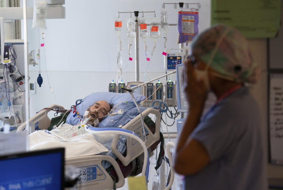 Registered Nurse Manjot Kaur Munday, pauses for a moment outside the room of COVID-19 patient Joseph Trudeau, 49, of Surrey, British Columbia, at the COVID-19 Intensive Care Unit at Surrey Memorial Hospital in Surrey, British Columbia, Friday, June 4, 2021. (Jonathan Hayward/The Canadian Press via AP)