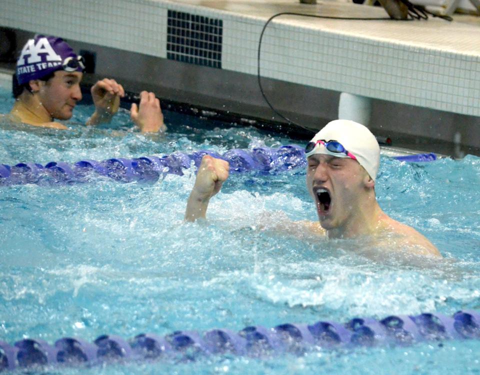 West Ottawa's Kevin Maas celebrates after winning the Division 1 state title in the 50 freestyle on Saturday at Holland Community Aquatic Center.