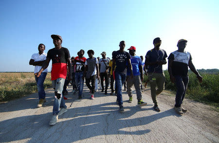African migrant laborers stage a march to protest against their work conditions in Italy, following the death of 16 of their colleagues in two separate road accidents, near Foggia, Italy August 8, 2018. REUTERS/Alessandro Bianchi