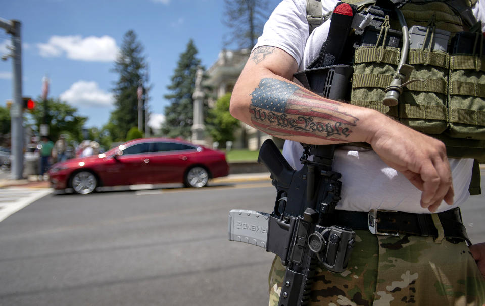 Second Amendment advocate Justin Hall of Roanoke stands guard with his firearm near the Marion, Va. courthouse and Confederate statue on July 3, 2020. (Andre Teague / Bristol Herald Courier via AP file)