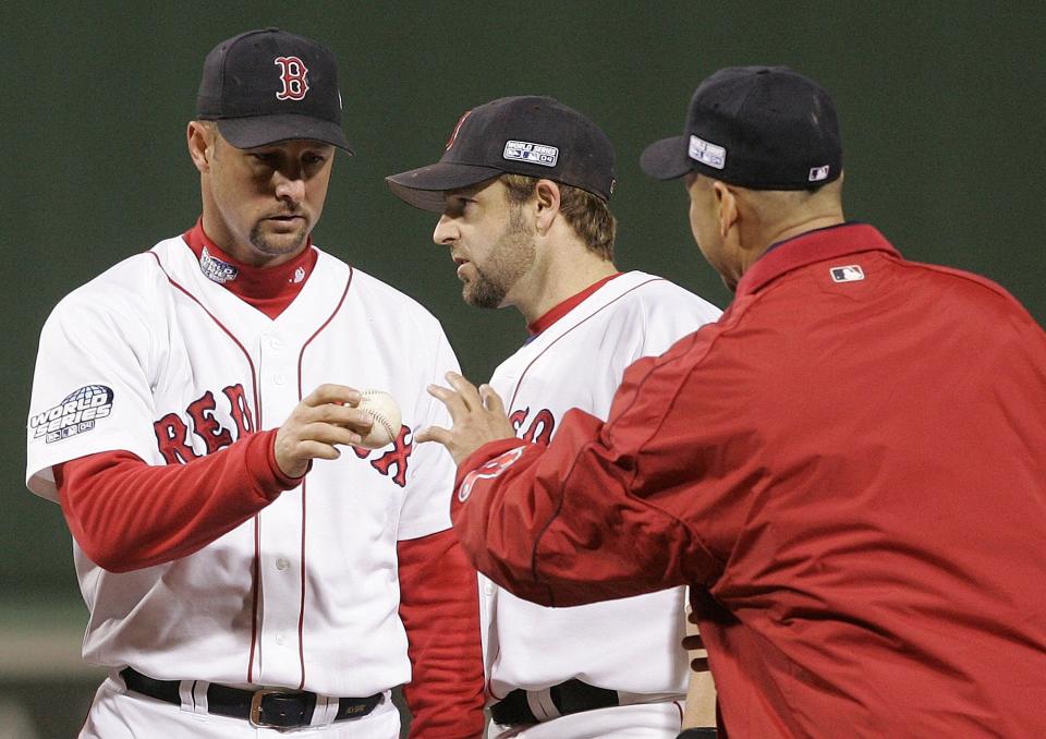 The late Boston Red Sox pitcher Tim Wakefield, left, was part of the 2004 championship team.