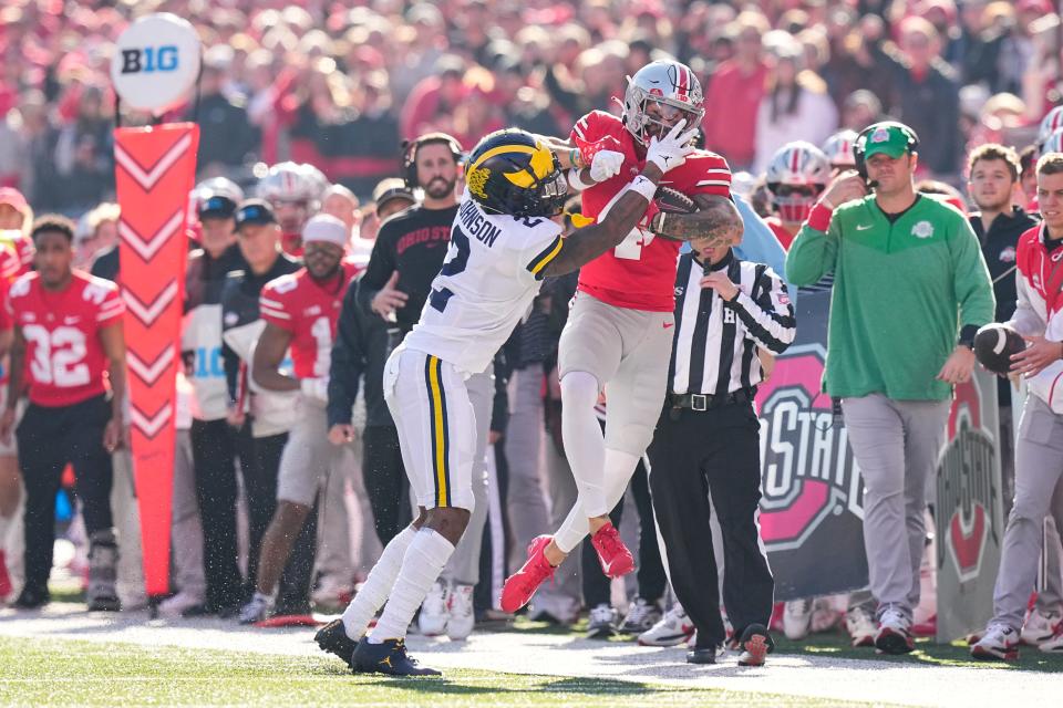 Nov 26, 2022; Columbus, Ohio, USA;  Michigan Wolverines defensive back Will Johnson (2) hits Ohio State Buckeyes wide receiver Julian Fleming (4) out of bounds during the first half of the NCAA football game at Ohio Stadium. Mandatory Credit: Adam Cairns-The Columbus Dispatch