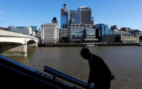 A man walks toward London Bridge opposite the City of London, Britain, September 21, 2018. REUTERS/Peter Nicholls