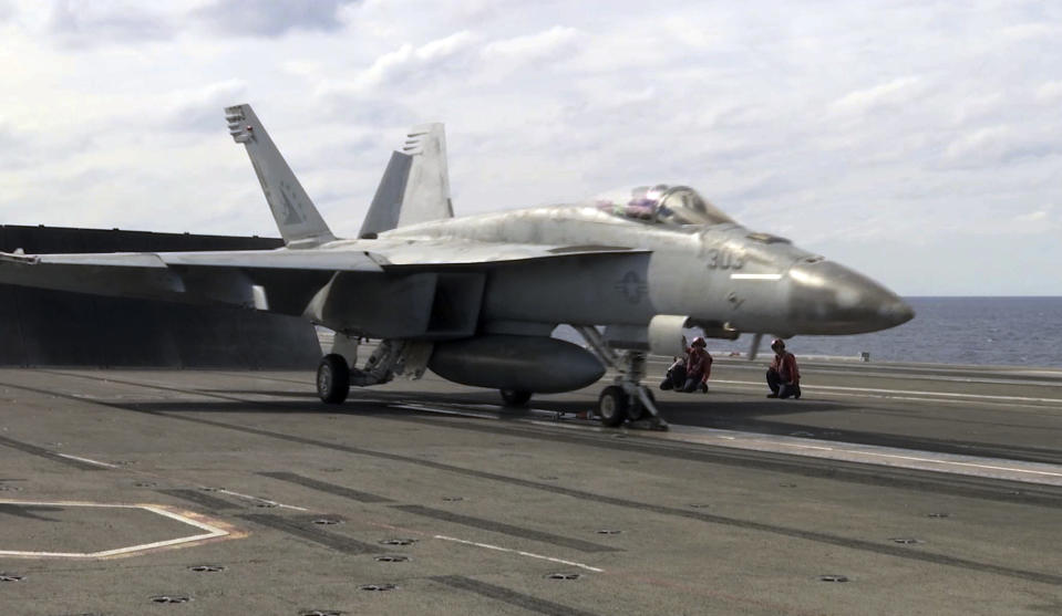 In this image made from Nov. 3, 2018, video, an F-18 fighter jet prepares to take off from the USS Ronald Reagan during maneuvers in the waters off Iwakuni, Japan. On Monday, while on routine operations in the Philippine Sea, an F-18 from the USS Reagan crashed into the sea but its two aviators were rescued safely. (AP Photo/Richard Columbo)