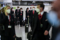 Spanish airline Iberia crew workers wearing face masks to prevent the spread of coronavirus arrive at Adolfo Suarez-Barajas international airport, outskirts Madrid, Spain, Sunday, Oct. 25, 2020. Spanish Prime Minister Pedro Sánchez has declared a second nationwide state of emergency in hopes of stemming a resurgence in coronavirus infections. (AP Photo/Manu Fernandez)