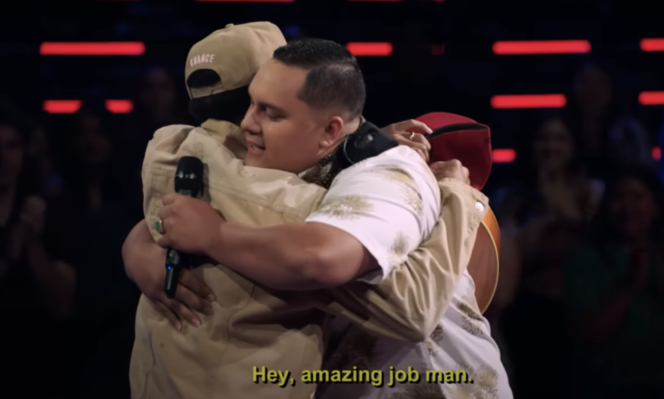 Closeup of Kamalei and Chance the Rapper hugging on "The Voice"