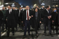 Armenian Prime Minister Nikol Pashinyan, center, and his wife Anna Akobyan walk with supporters during a rally in his support in the center of Yerevan, Armenia, Monday, March 1, 2021. Amid escalating political tensions in Armenia, supporters of the country's embattled prime minister and the opposition are staging massive rival rallies in the capital of Yerevan. Prime Minister Nikol Pashinyan has faced opposition demands to resign since he signed a peace deal in November that ended six weeks of intense fighting with Azerbaijan over the Nagorno-Karabakh region. (Hayk Baghdasaryan/PHOTOLURE via AP)