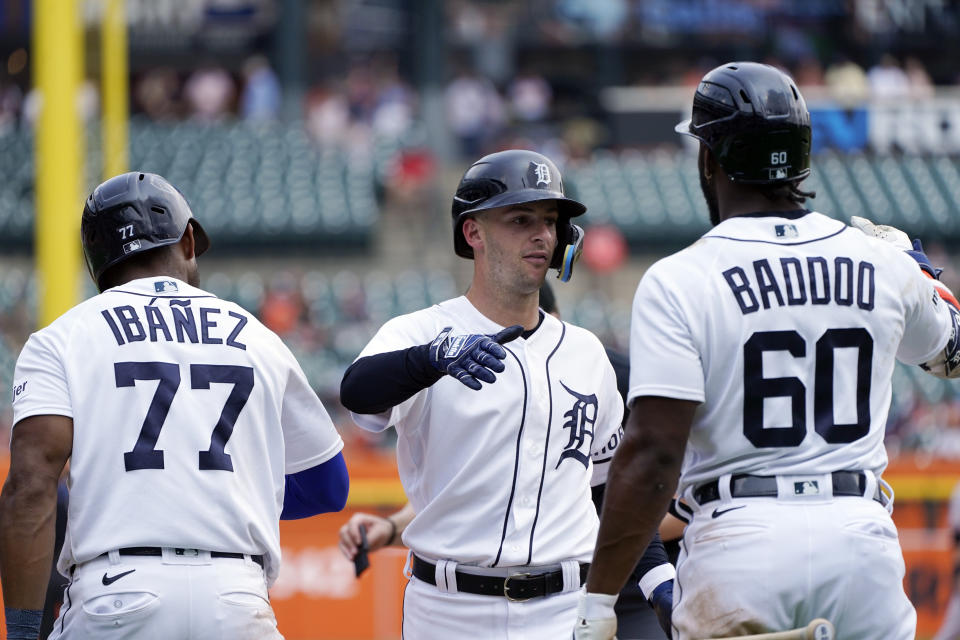 Detroit Tigers' Zack Short, center, is greeted by Andy Ibanez and Akil Baddoo after his two-run home run during the eighth inning of a baseball game against the San Francisco Giants, Monday, July 24, 2023, in Detroit. (AP Photo/Carlos Osorio)