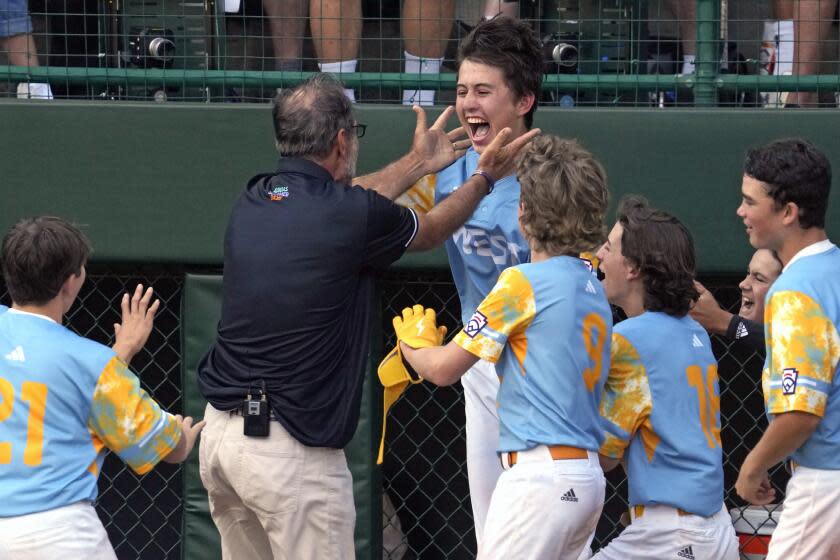 El Segundo, Calif.'s Louis Lappe, right center, celebrates with manager Danny Bole.