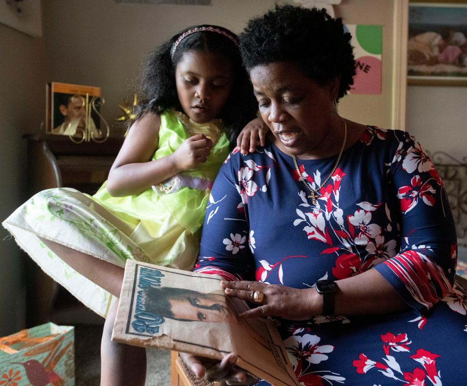 Charmeal Neely shows some of her Elvis memorabilia as her 8-year-old daughter Aria Alexander looks over her shoulder on Thursday, May 26, 2022, in Whitehaven. Neely said she first became interested in Elvis after her daughterÕs interest in visiting Graceland prompted a trip. 
