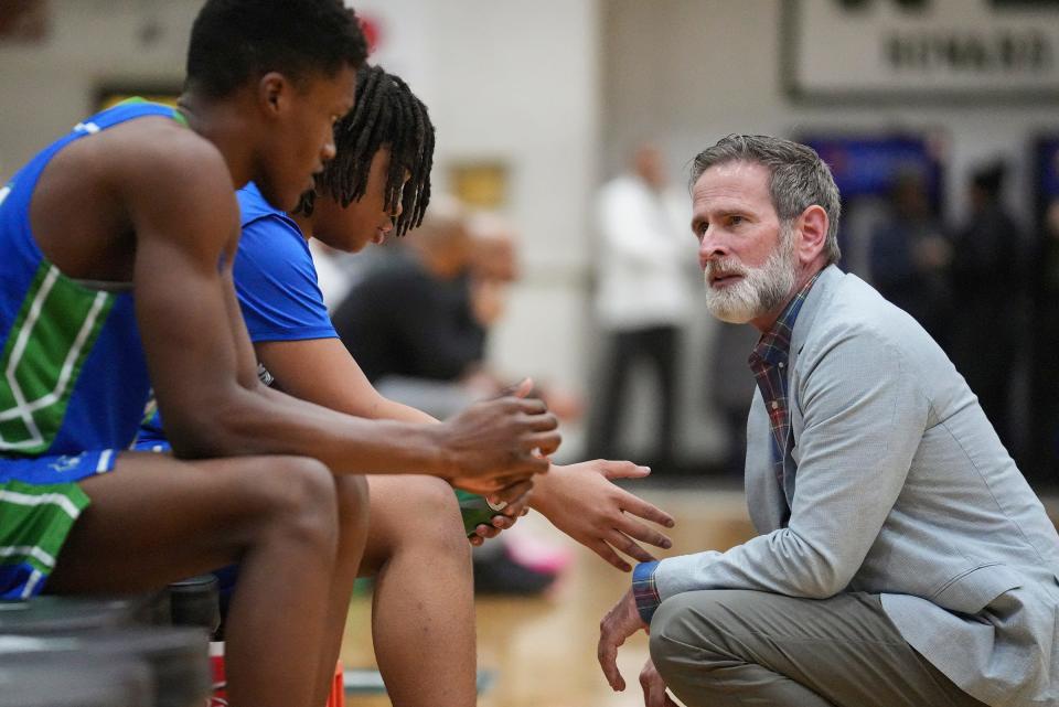 Providence Cristo Rey head coach Scott Miller, right, talks to Taviar Duerson, left, and Andrew Murphy on Tuesday, Jan. 16, 2024, during a game against Arsenal Technical. "I am super passionate about developing young people and seeing them get better as people and as human beings," Miller said. "And if basketball happens to be the tool that we use to do that, so be it."