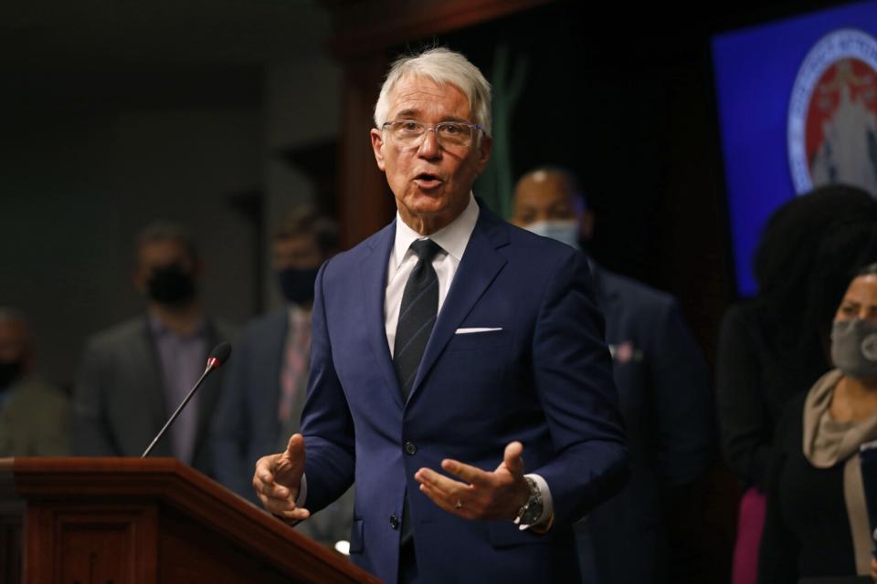 A man speaks at a podium during a press conference