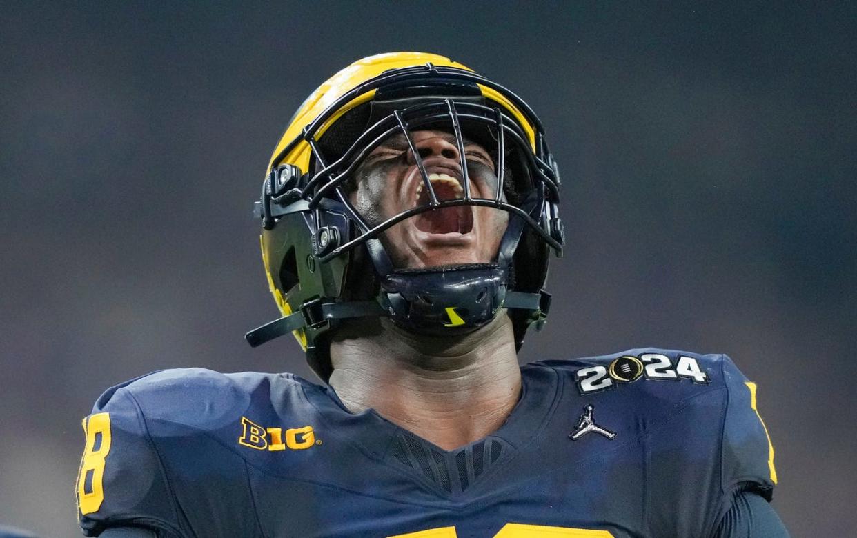 Michigan defensive lineman Kenneth Grant (78) celebrates a sack on Washington quarterback Michael Penix Jr. (9) in the second quarter during the College Football Playoff national championship game against Washington at NRG Stadium in Houston, Texas on Monday, January 8, 2024.