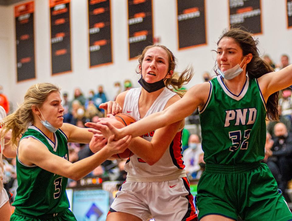 Peoria Notre Dam's Molly Rickey, left, and Elizabeth Hanley try to strip the ball from Winnebago's Renee Rittmeyer during the third quarter of their game on Saturday, Jan. 15, 2022, in Winnebago.