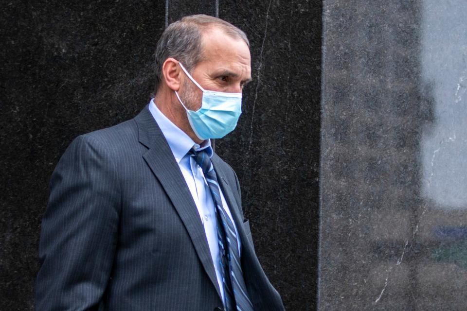 Former Macomb County prosecutor Eric Smith walks outside the United States District Court in Detroit on Feb. 16, 2022. Smith was sentenced for stealing money from his campaign fund.