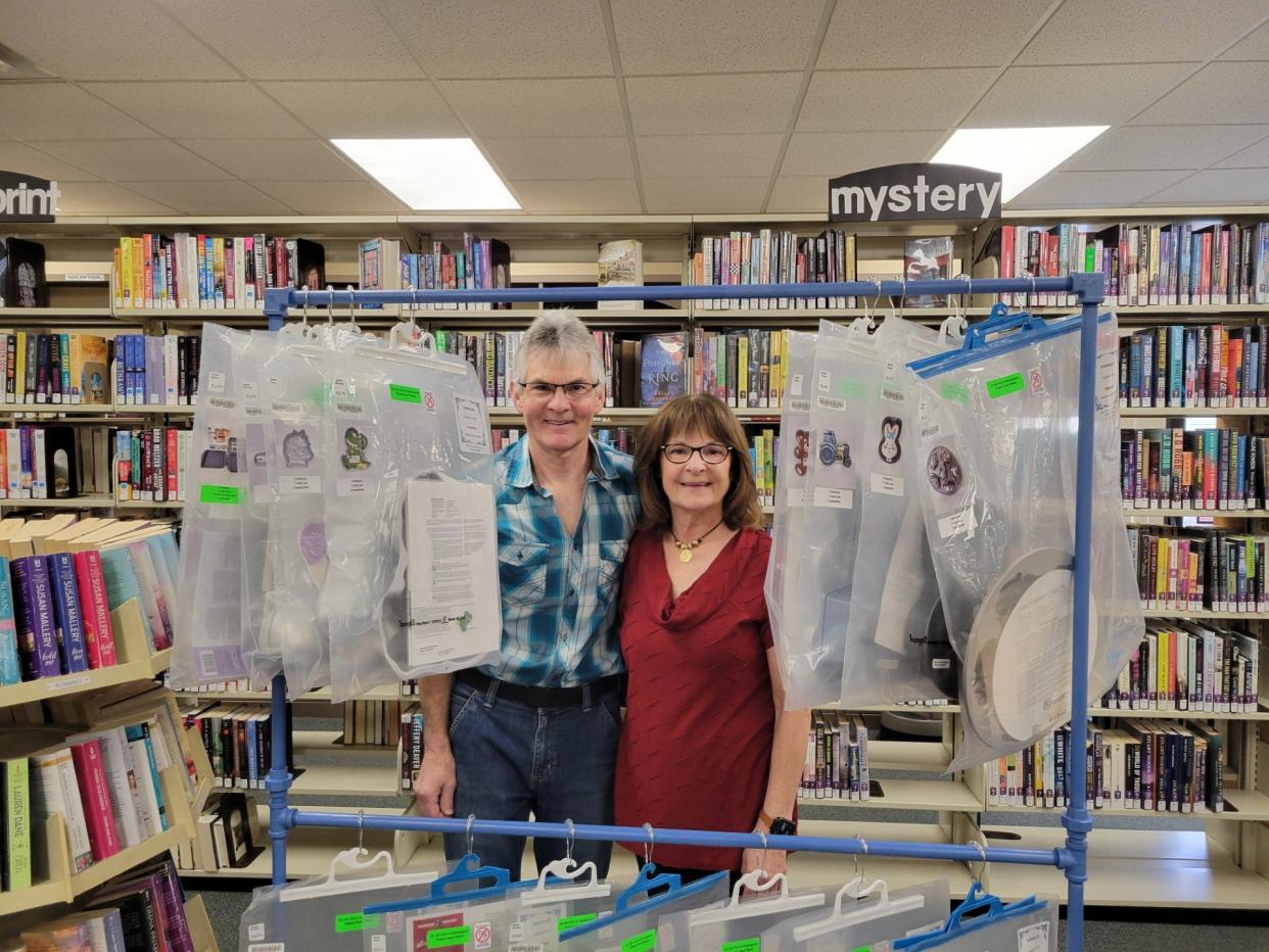 Two of Virginia (Ginny) O’Neill's children, Kenny O'Neill and Debbie O'Neill Hine, are shown with some of the shaped pans in the new Virginia (Ginny) O’Neill Memorial Cake Pan Collection, which will debut Monday at the Erie Branch Library.