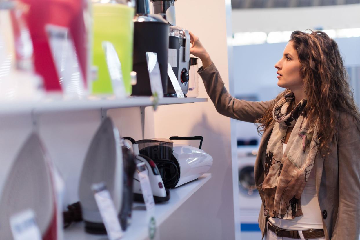 woman looking at juicers in store