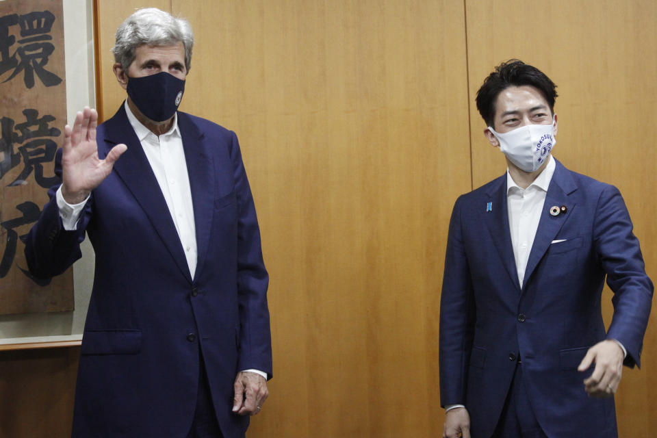 U.S. Special Presidential Envoy for Climate John Kerry, left, poses with Japanese Environment Minister Shinjiro Koizumi during a meeting at the latter's office in Tokyo, Tuesday, Aug. 31, 2021. Kerry was in Tokyo to discuss efforts to fight climate change with top Japanese officials ahead of a United Nations conference in November. (AP Photo/Koji Sasahara, Pool)