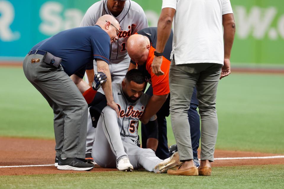 Detroit Tigers' Derek Hill is helped up off the field during the fifth inning of a baseball game against the Tampa Bay Ray Saturday, Sept. 18, 2021, in St. Petersburg, Florida.