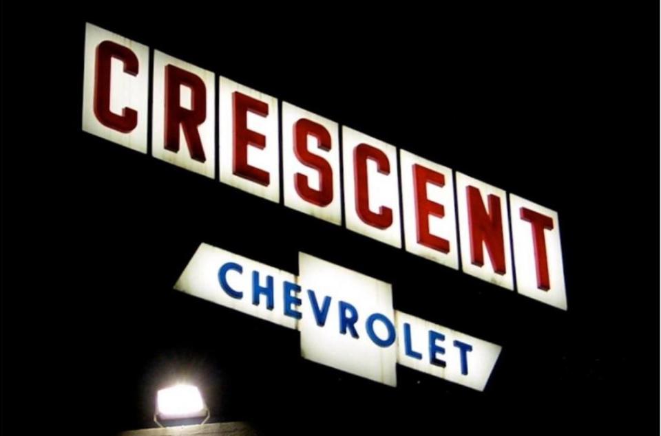 The Crescent Chevrolet sign at 555 17th St. in Des Moines shines at night in this undated photo. The sign hasn't lit up since the dealership moved from that location in 2007.