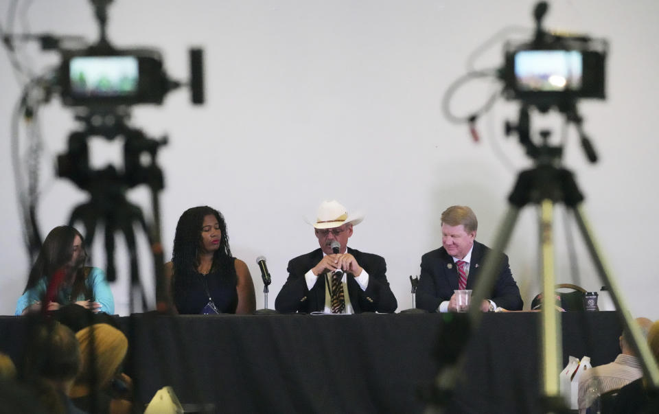 From left, Audrey Trujillo, candidate for New Mexico Secretary of State, Kristina Karamo, candidate for Michigan Secretary of State, Mark Finchem, candidate for Arizona Secretary of State and Jim Marchant, candidate for Nevada Secretary of State, attend a conference on conspiracy theories about voting machines and discredited claims about the 2020 presidential election at a hotel in West Palm Beach, Fla., Saturday, Sept. 10, 2022. The event featured Republicans running for statewide offices that oversee elections in some of the most important battleground states. (AP Photo/Jim Rassol)