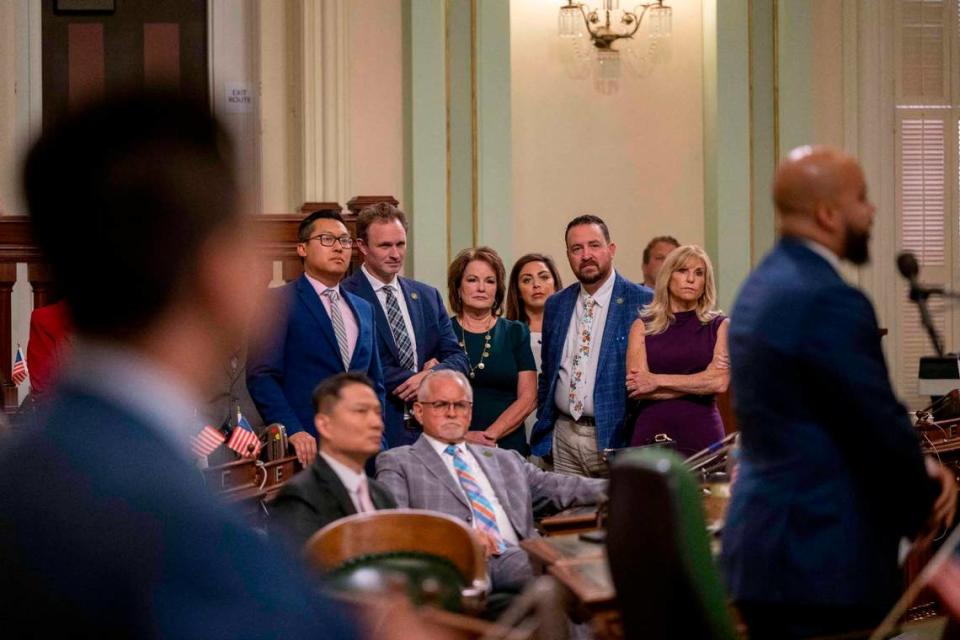 Legislators, including, Assembly Republican Leader James Gallagher of Yuba City, second from left in center, and Senate Bill 17 author Sen. Shannon Grove, R-Bakersfield, center, listen to speakers during an Assembly session at the Capitol on Thursday, July 13, 2023, prior to a vote to revive the child sex trafficking bill that was killed by California Democrats but caught the attention of Gov. Gavin Newsom who intervened.