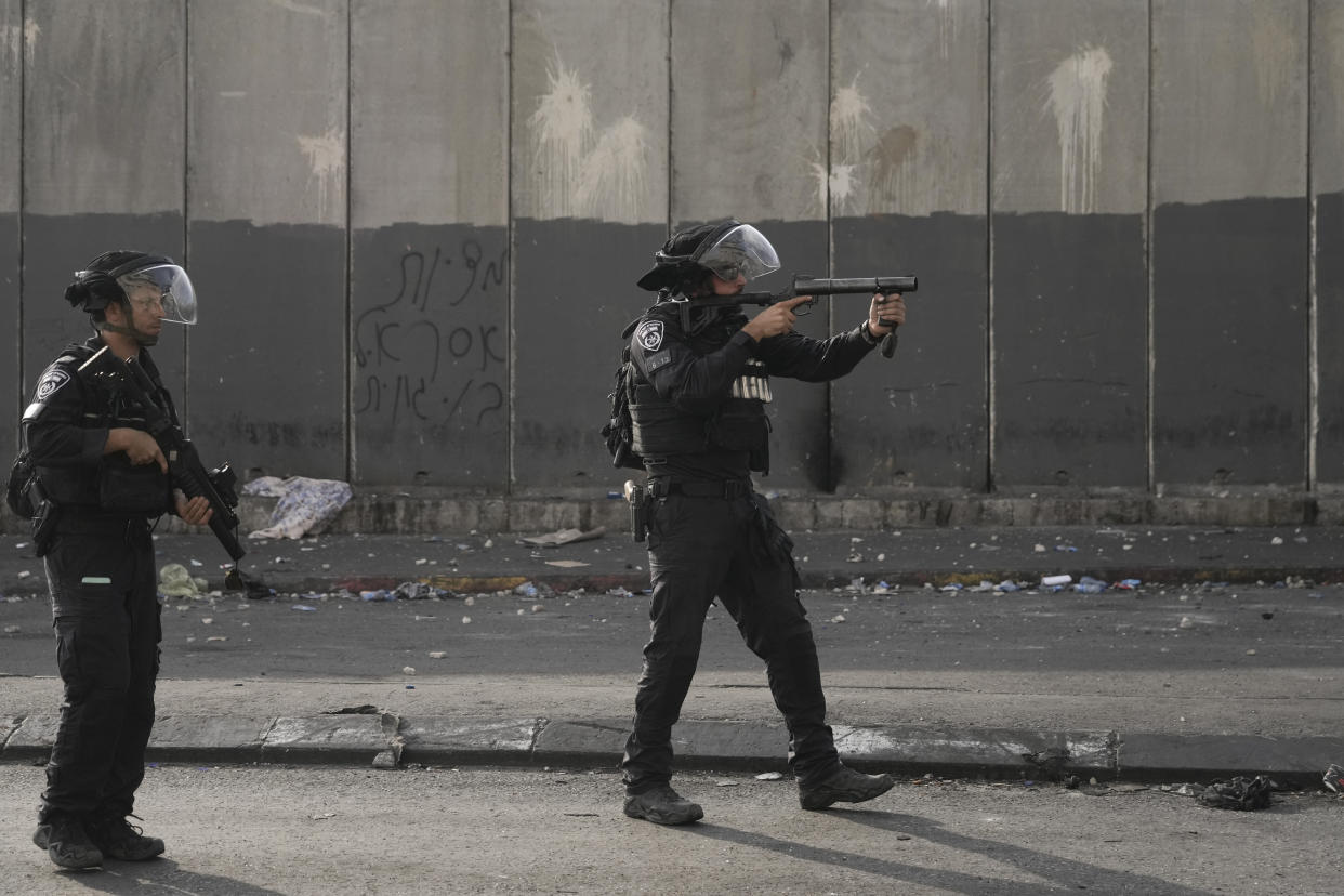 Israeli police clashes with Palestinians in Shuafat refugee camp in Jerusalem, Wednesday, Oct.12. 2022. Israeli police have been operating in the Shuafat refugee camp in Jerusalem's eastern sector to hunt for a suspect in a deadly shooting attack at a checkpoint on Sunday that killed a soldier. (AP Photo/Mahmoud Illean)