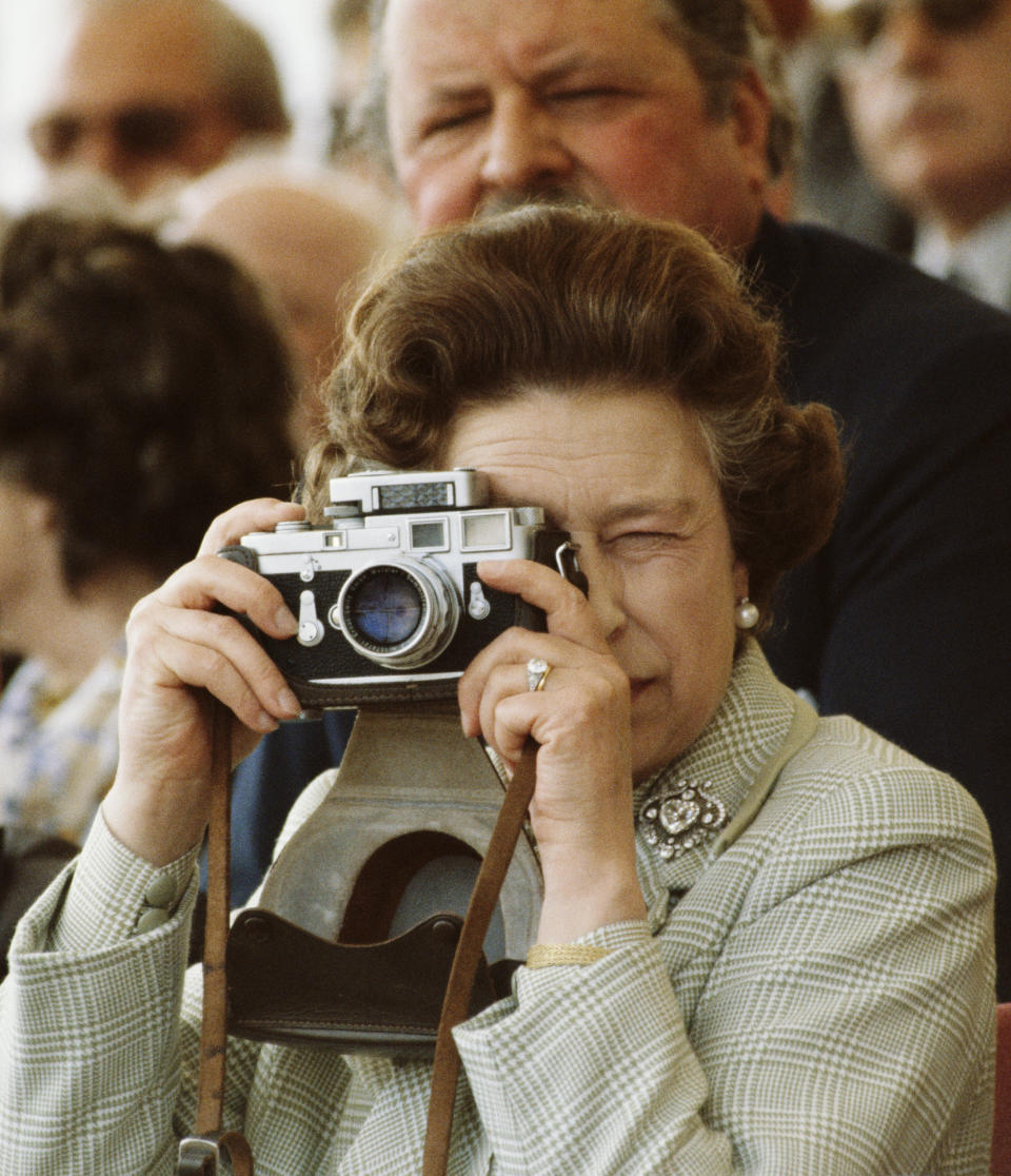 Queen Elizabeth II taking Pictures Of Her Husband 