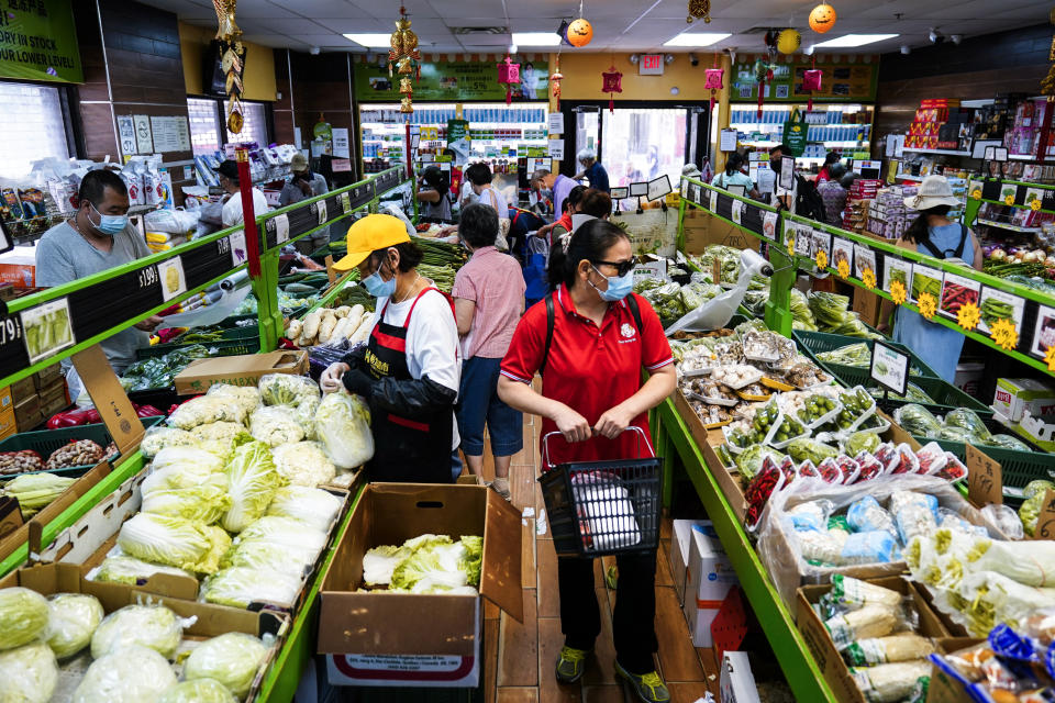 Customers shop for produce in the Chinatown neighborhood of Philadelphia, Friday, July 22, 2022. Organizers and members of Philadelphia's Chinatown say they were surprised by the 76ers' announcement that they hope to build a $1.3 billion arena just a block from the community’s gateway arch. (AP Photo/Matt Rourke)