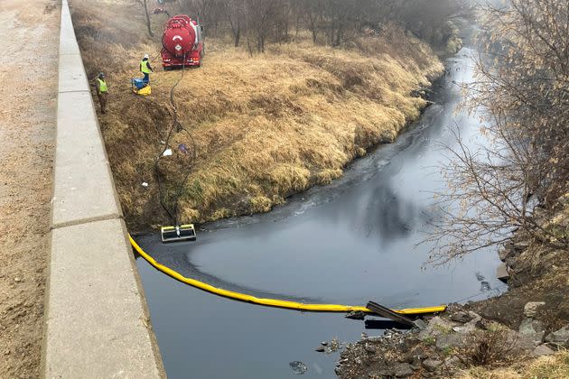 A remediation company deploys a boom on the surface of an oil spill after a Keystone pipeline ruptured at Mill Creek in Washington County, Kansas.