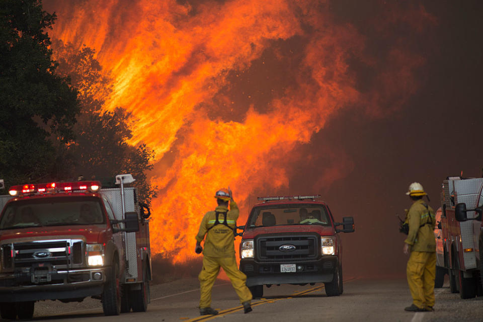 <p>Firefighters are forced to retreat as flame close in on them in Placerita Canyon at the Sand Fire on July 24, 2016 in Santa Clarita, California. Triple-digit temperatures and dry conditions are fueling the wildfire.</p>