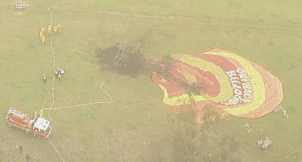 Fire crews extinguished the blaze after a hot air balloon caught fire over Victoria’s Yarra Valley and made an emergency landing. Source: 7 News