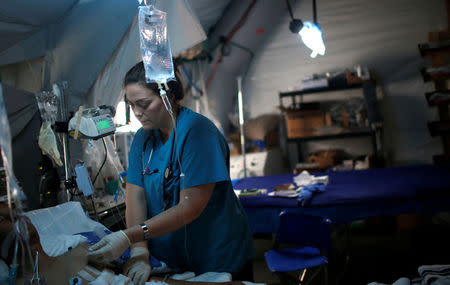 A foreign volunteer works at the emergency field hospital which is run by the US Christian charity Samaritan's Purse, eastern Mosul, Iraq March 22, 2017. Picture taken March 22, 2017. REUTERS/Suhaib Salem