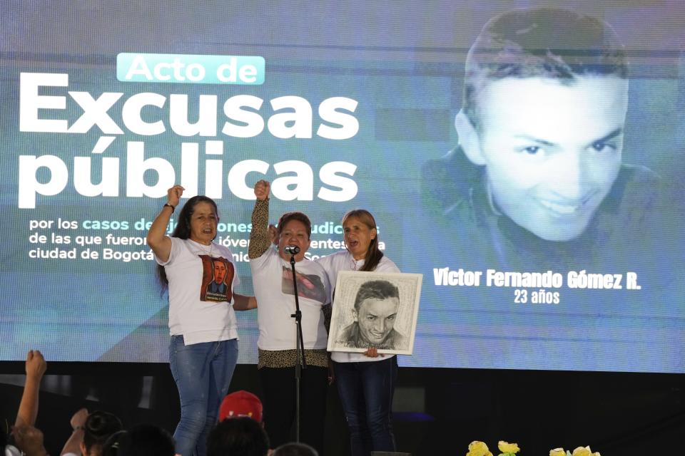 Carmenza Gomez, center, mother of Victor Gomez, one of the 19 young people who were falsely presented as guerrillas killed in combat by the Colombian army during the country's internal conflict, talks during an act of recognition and public apology by the state for their extrajudicial execution, in Bogota, Colombia, Tuesday, Oct. 3, 2023. (AP Photo/Fernando Vergara)