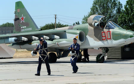 Su-25 fighter jet pilots, who took part in the Russian mission in Syria, walk on the runway after landing at a military airport in Krasnodar Region, Russia July 4, 2018. REUTERS/Sergey Pivovarov