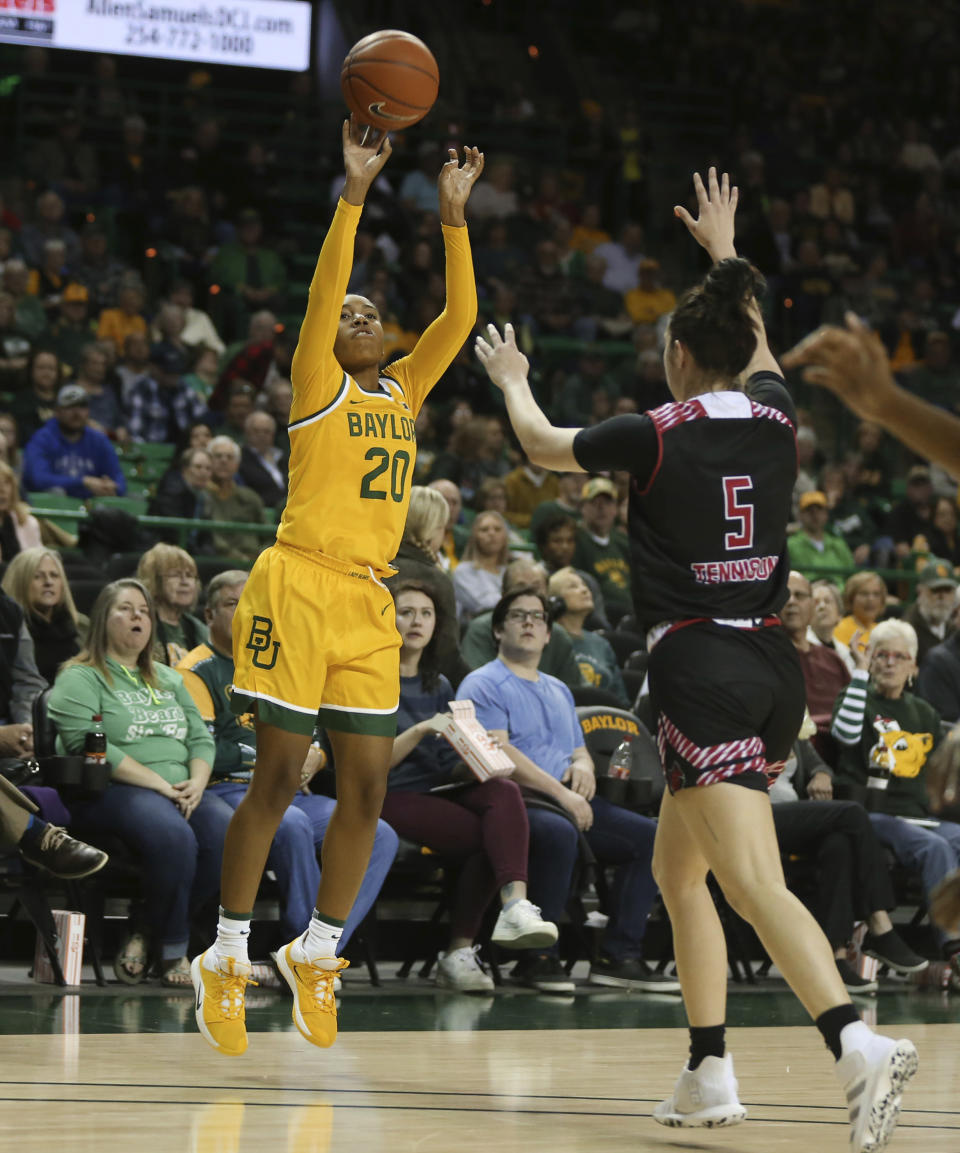 Baylor guard Juicy Landrum, left, scores past Arkansas State guard Payton Tennison, right, on a 3-point shot in the first half of an NCAA college basketball game, Wednesday, Dec. 18, 2019, in Waco, Texas. (Rod Aydelotte/Waco Tribune-Herald via AP)