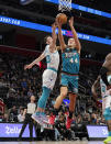 Detroit Pistons forward Bojan Bogdanovic (44) attempts a lap as Charlotte Hornets forward Gordon Hayward (20) defends during the first half of an NBA basketball game, Friday, Feb. 3, 2023, in Detroit. (AP Photo/Carlos Osorio)