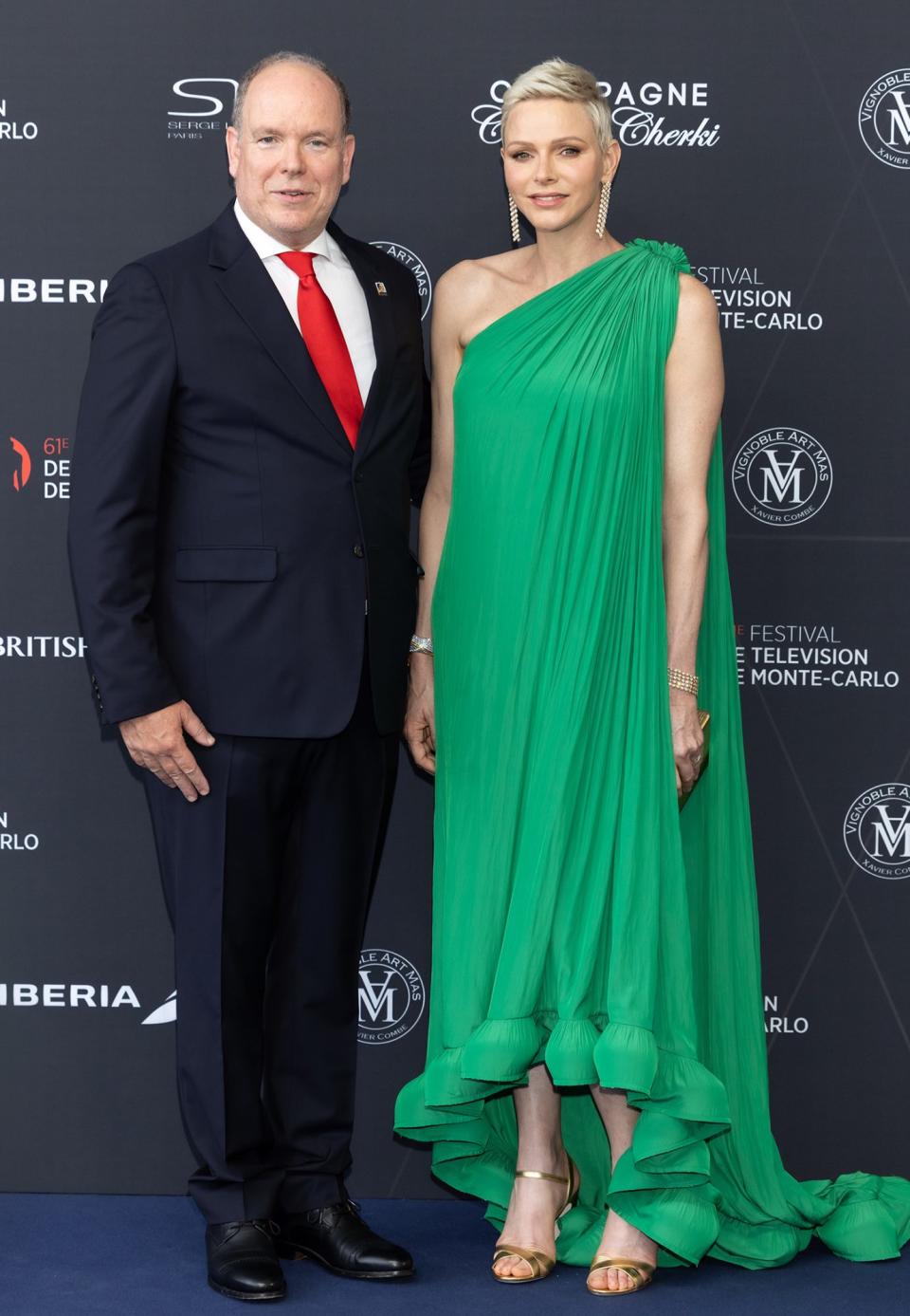 <p>At the opening of the 61st Monte Carlo Television Festival, the former Olympian wore a striking toga-style green gown by Lanvin gown. The asymmetrical ensemble was accessorized with jewelry from Van Cleef & Arpels, while a pair of long gold drop earrings accentuated her blonde pixie hairstyle.</p>