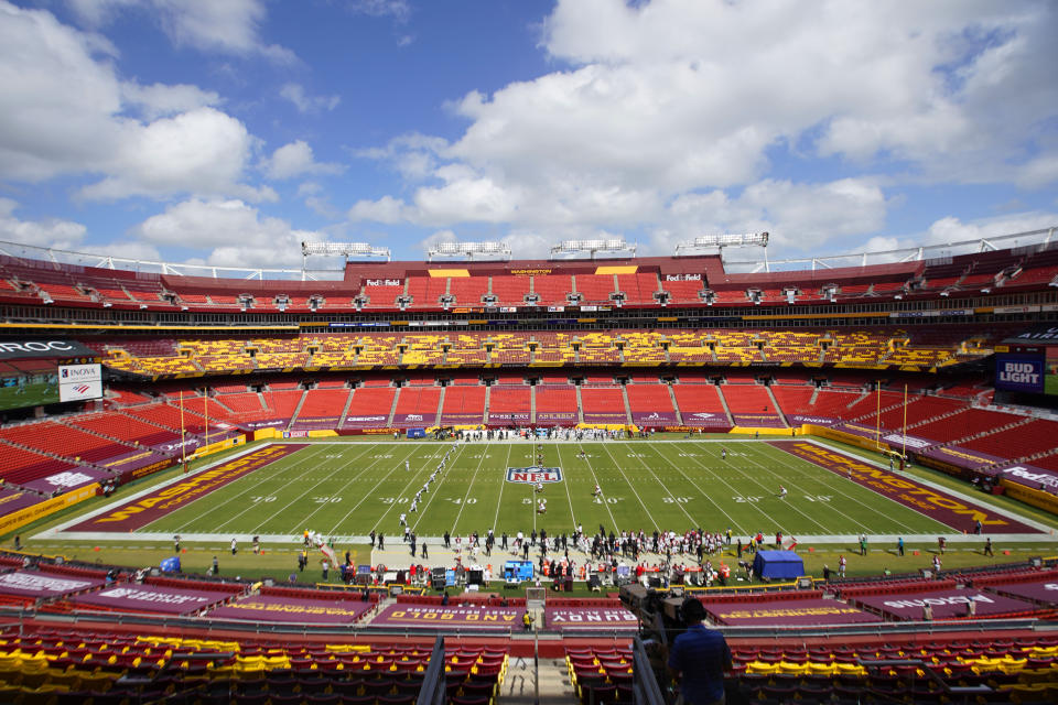 Members of the Washington Football Team and Philadelphia Eagles lineup on the field for the opening kickoff to start the first half of an NFL football game, Sunday, Sept. 13, 2020, in Landover, Md. (AP Photo/Al Drago)