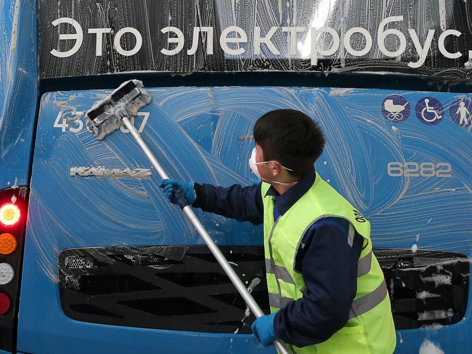 An employee disinfecting an electric bus at Moscow's trolleybus depot No 6. on March 3 2020 Mikhail Tereshchenko\TASS via Getty Images