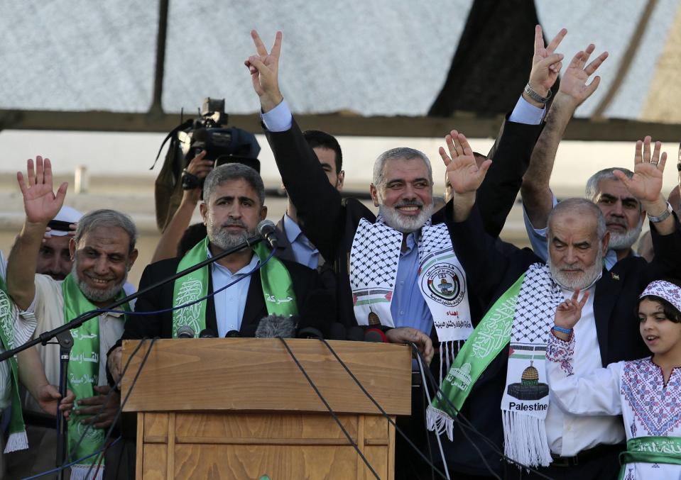 Hamas Gaza leader Ismail Haniyeh flashes a victory sign as he appears for the first time since the start of a seven-week conflict during a rally by Palestinians celebrating what they said was a victory over Israel in Gaza City