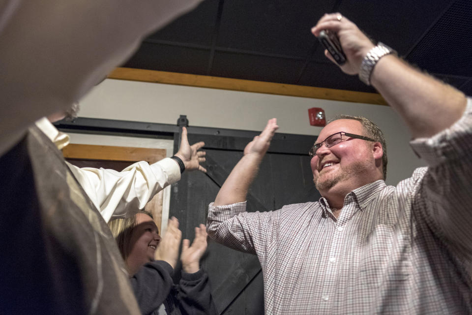 Elwood Caudill, Jr, right, celebrates winning the Rowan County Clerk office Tuesday, Nov. 6, 2018, in Morehead, Ky. (AP Photo/John Flavell)